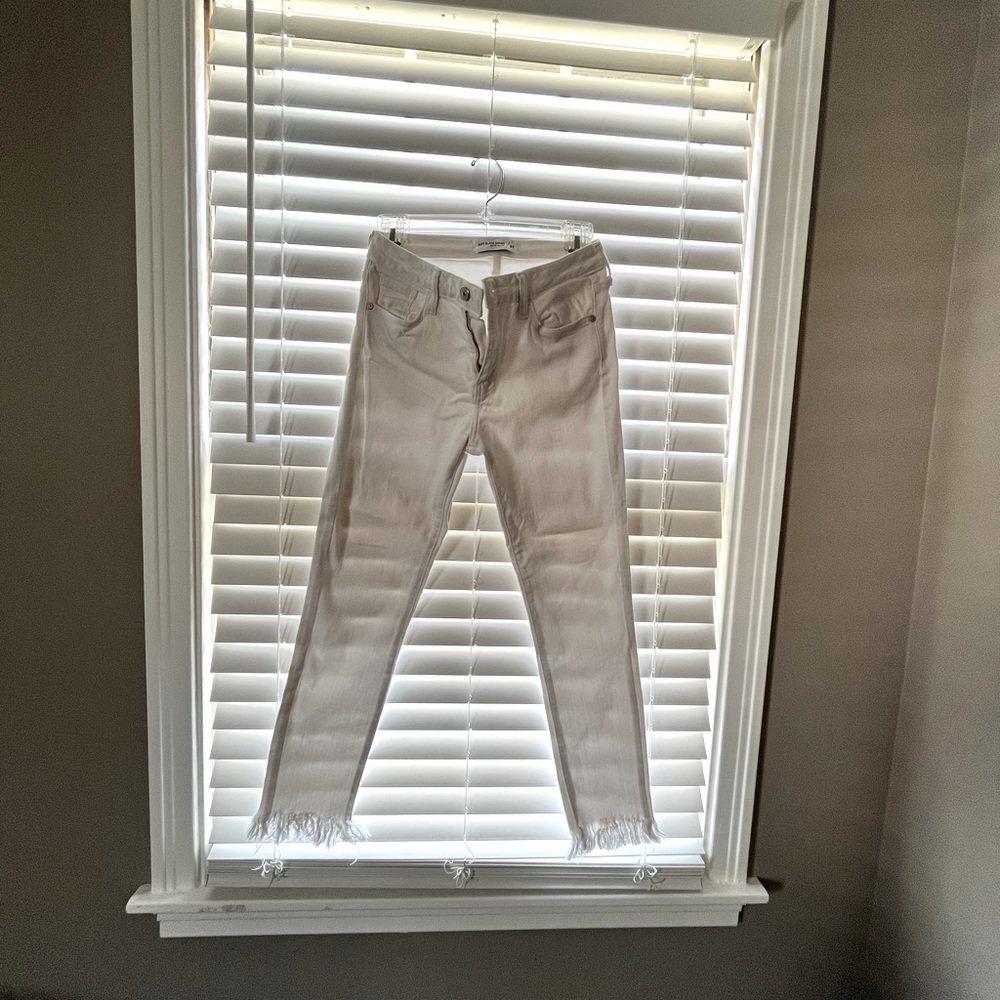 White denim pants with fringe bottom